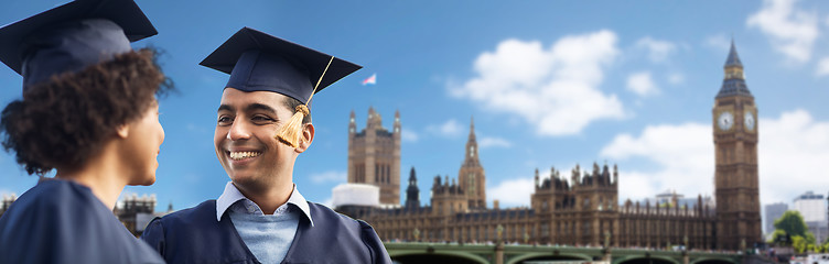 Image showing happy students or bachelors in mortar boards