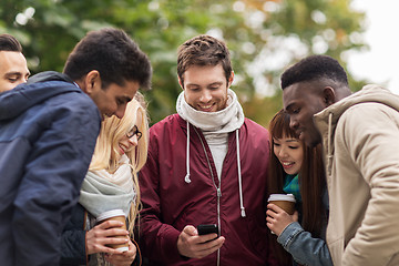 Image showing happy friends with smartphone and coffee outdoors