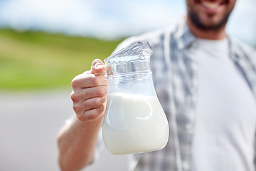 Image showing man or farmer with jug of milk at countryside