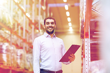 Image showing happy businessman with clipboard at warehouse