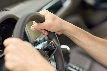 Image showing close up of male hands driving car