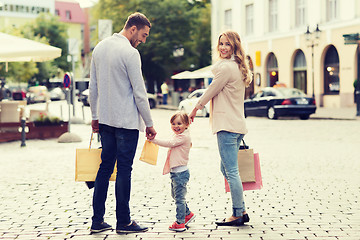 Image showing happy family with child and shopping bags in city