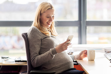 Image showing pregnant businesswoman with smartphone at office