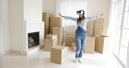 Image showing Happy young woman enjoying her VR headset