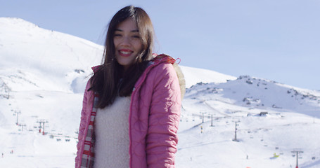 Image showing Carefree young woman in snowy ski resort