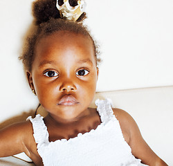 Image showing little pretty african american girl sitting in white chair weari