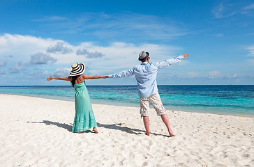 Image showing Vacation Couple walking on tropical beach Maldives.