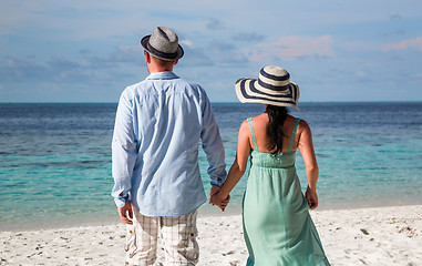Image showing Vacation Couple walking on tropical beach Maldives.