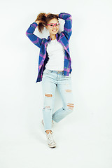 Image showing young pretty teenage hipster girl posing emotional happy smiling on white background, lifestyle people concept