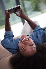 Image showing african american woman at home with digital tablet