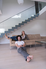 Image showing Young couple on the sofa watching television