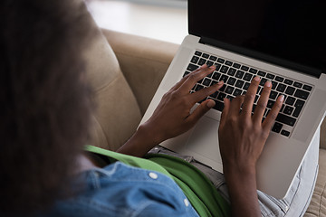 Image showing African American women at home in the chair using a laptop