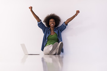 Image showing african american woman sitting on floor with laptop