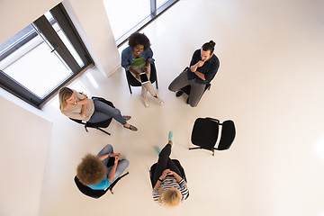 Image showing Multiethnic startup business team on meeting  top view