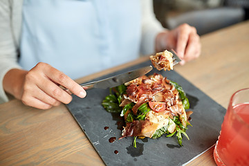 Image showing woman eating prosciutto ham salad at restaurant