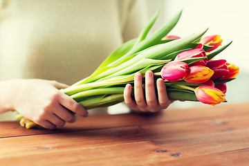 Image showing close up of woman holding tulip flowers