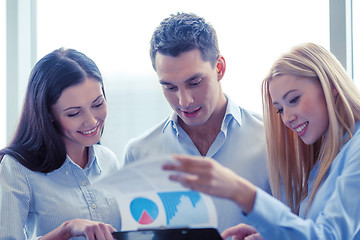 Image showing business team looking at clipboard