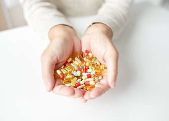 Image showing close up of old man hands holding medicine