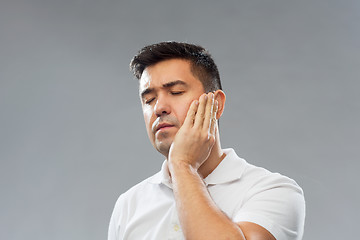 Image showing unhappy man suffering toothache