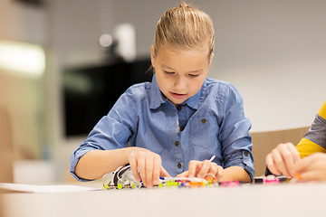 Image showing happy girl building robot at robotics school