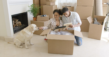 Image showing Young woman petting her pet dog