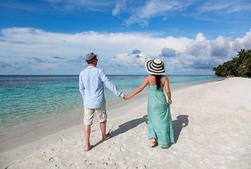 Image showing Vacation Couple walking on tropical beach Maldives.