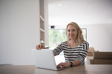 Image showing Young woman with laptop at home