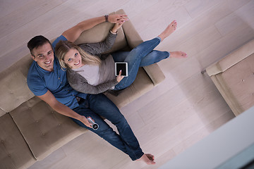 Image showing youg couple in living room with tablet top view