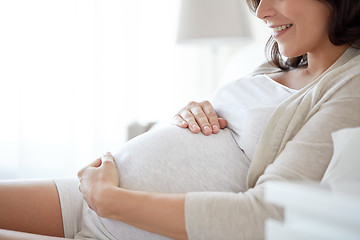 Image showing close up of happy pregnant woman in bed at home