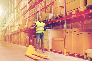 Image showing man with loader and clipboard at warehouse