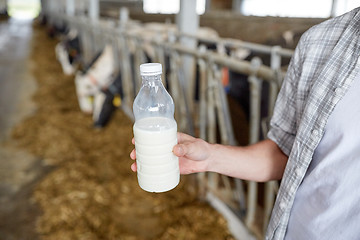 Image showing close up of man or farmer with milk on dairy farm