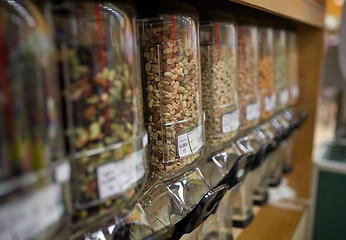 Image showing row of jars with nuts and seeds at grocery store