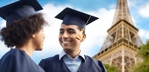 Image showing happy students or bachelors over eiffel tower