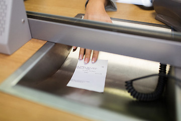 Image showing clerk giving receipt at bank or currency exchanger
