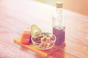 Image showing close up of food and olive oil bottle on table