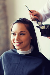 Image showing happy woman with stylist coloring hair at salon