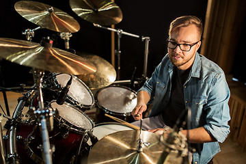 Image showing male musician playing drums and cymbals at concert