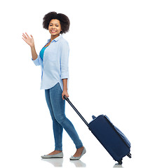 Image showing happy woman with travel bag waving hand