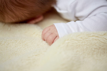 Image showing close up of baby lying on soft furry blanket