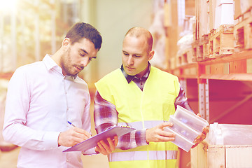 Image showing worker and businessmen with clipboard at warehouse