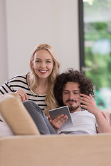 Image showing couple relaxing at  home with tablet computers