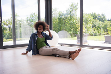 Image showing african american  woman  sitting near window