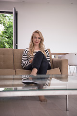 Image showing woman sitting on sofa with mobile phone