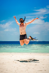 Image showing Funny man jumping in flippers and mask.