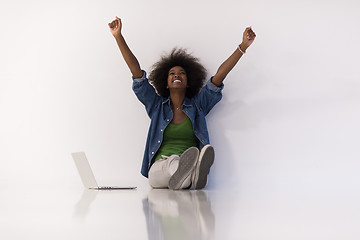 Image showing african american woman sitting on floor with laptop