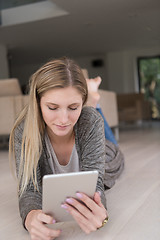 Image showing young women used tablet computer on the floor