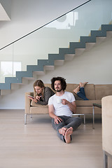 Image showing couple relaxing at  home with tablet computers