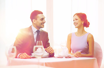 Image showing smiling couple looking at each other at restaurant