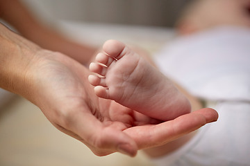 Image showing close up of newborn baby foot in mother hand