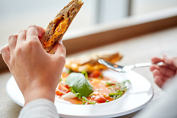 Image showing close up of woman eating soup with sandwich